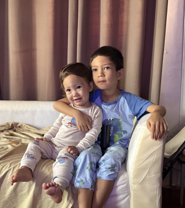 Jacob with his arm around Riley sat on the sofa watching TV.
